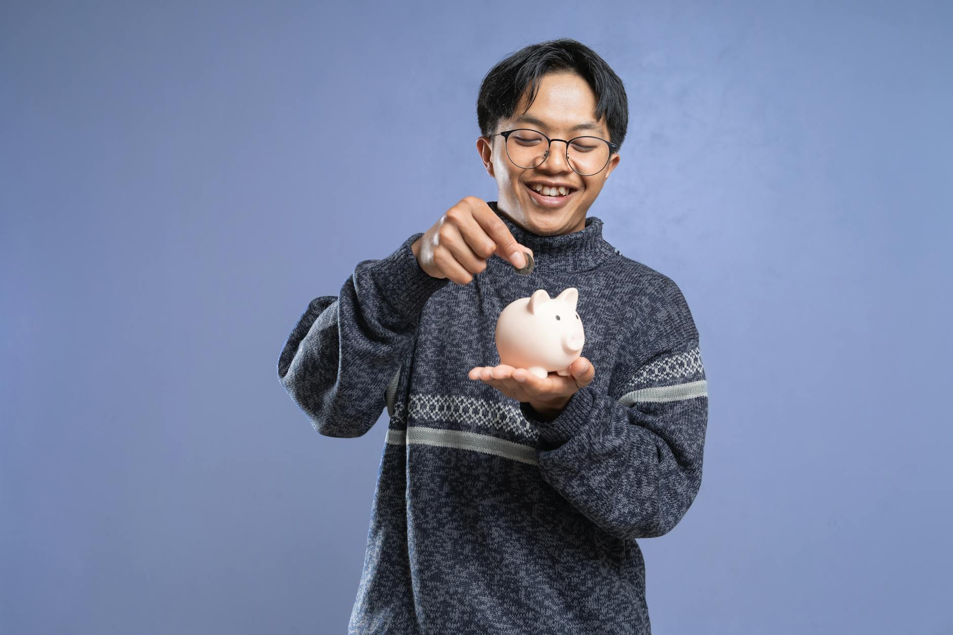 Student saving into a piggy bank representing extra financial support like grants and bursaries
