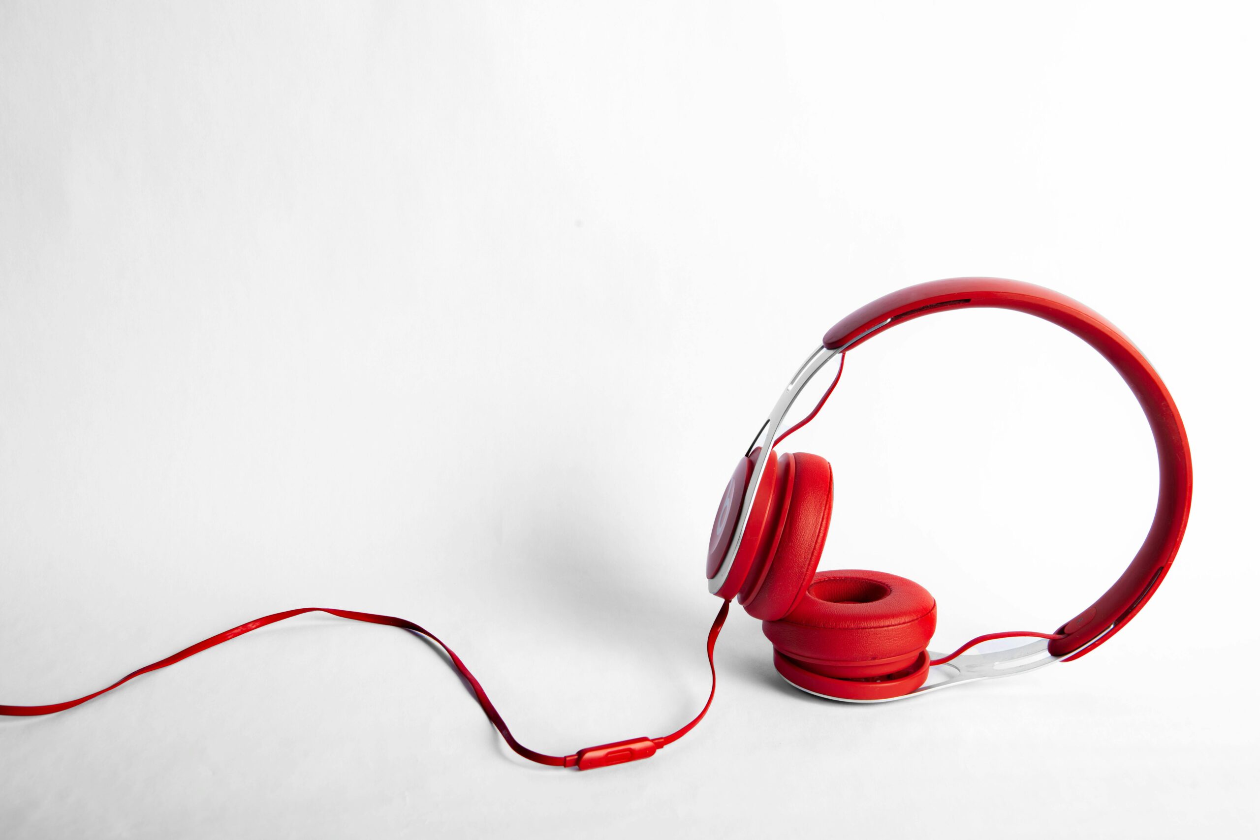 Tech gadget discounts laid out: headphones, laptop and phone on a student desk