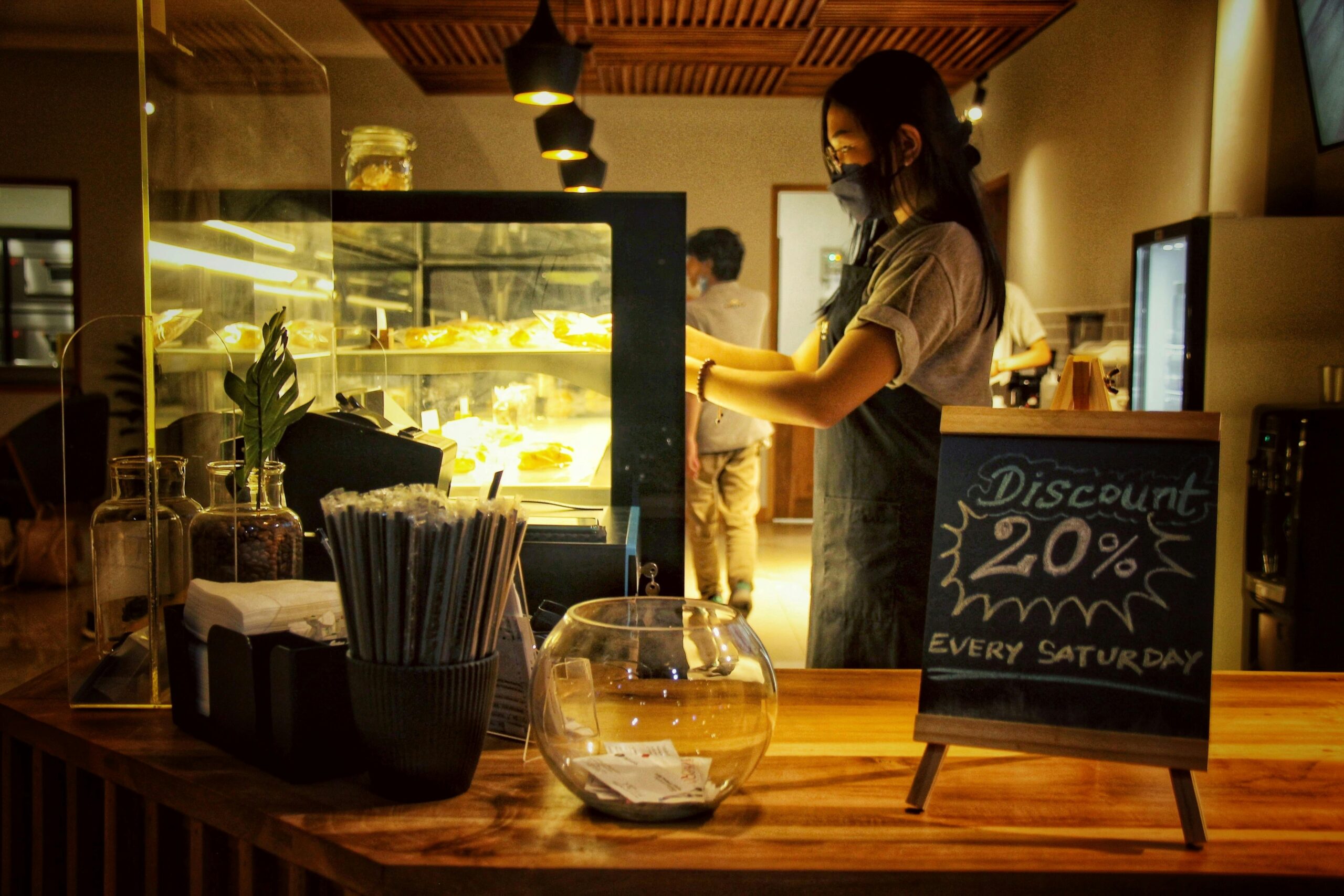 Student using a discount card at a coffee shop counter