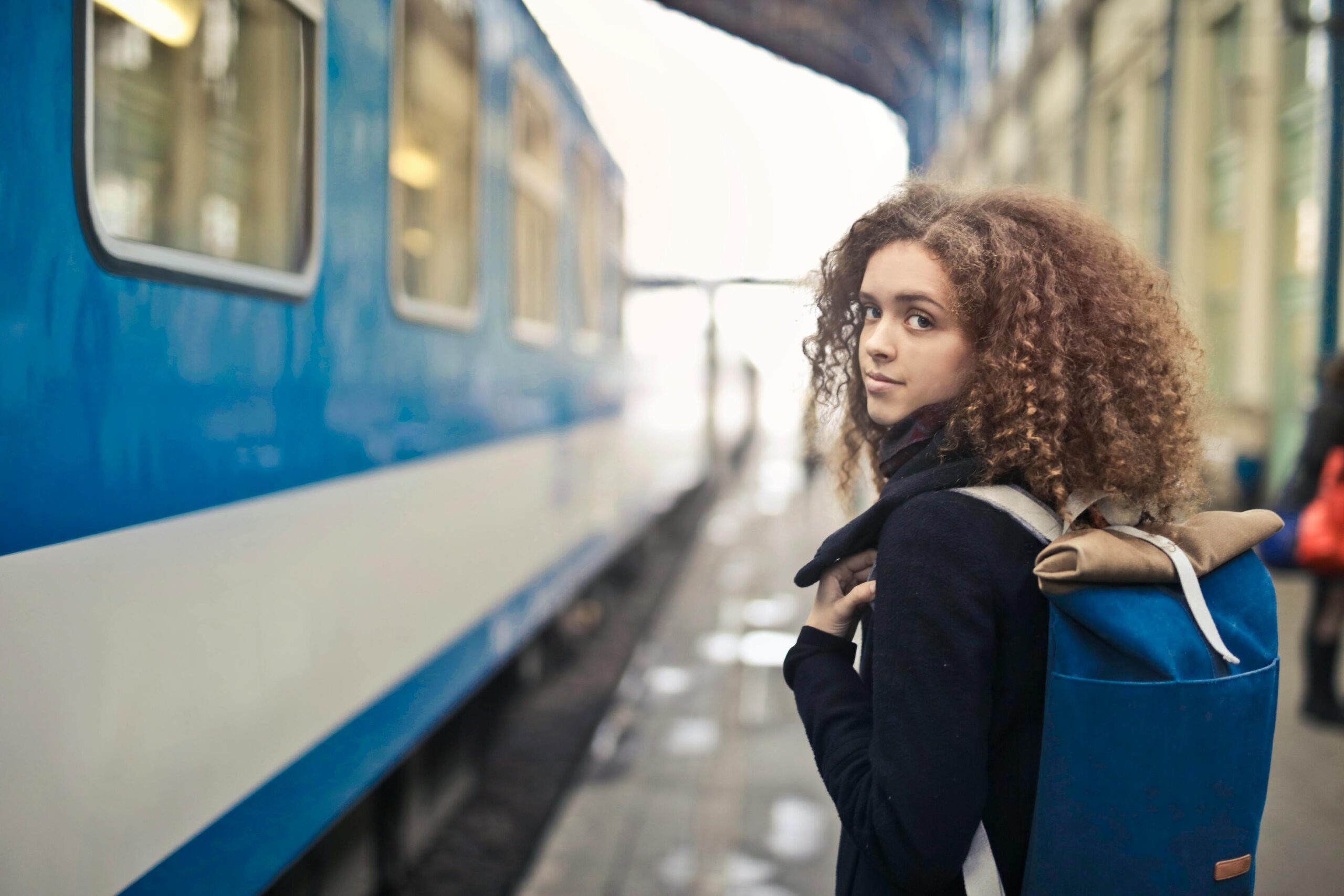 Young person travelling by train with a railcard discount