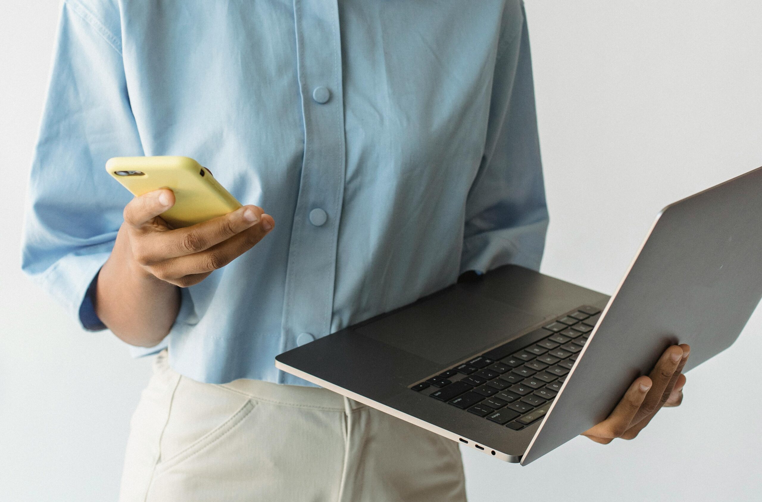 Student comparing broadband deals on a laptop and phone