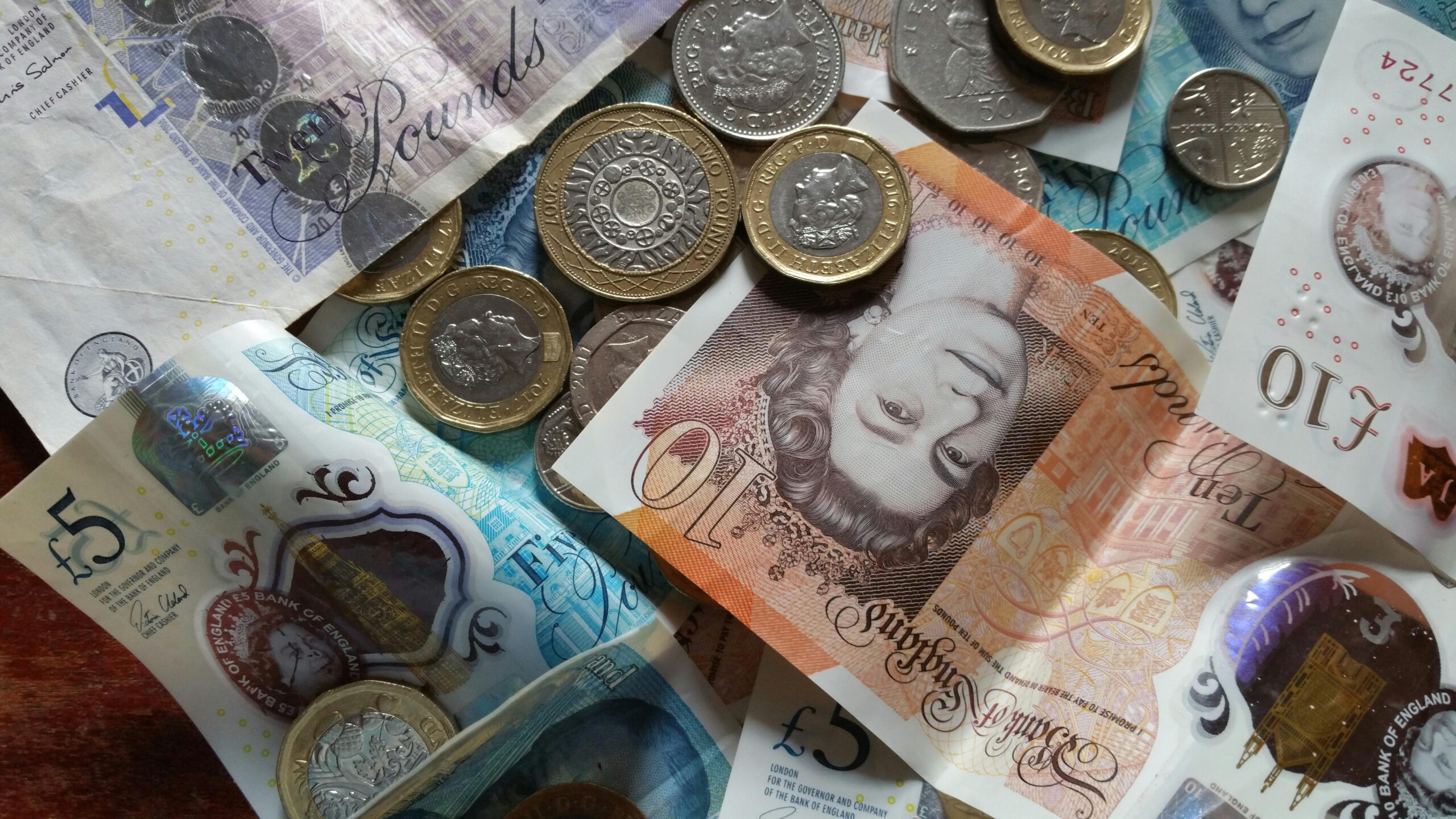British pound notes and coins representing take-home salary after deductions