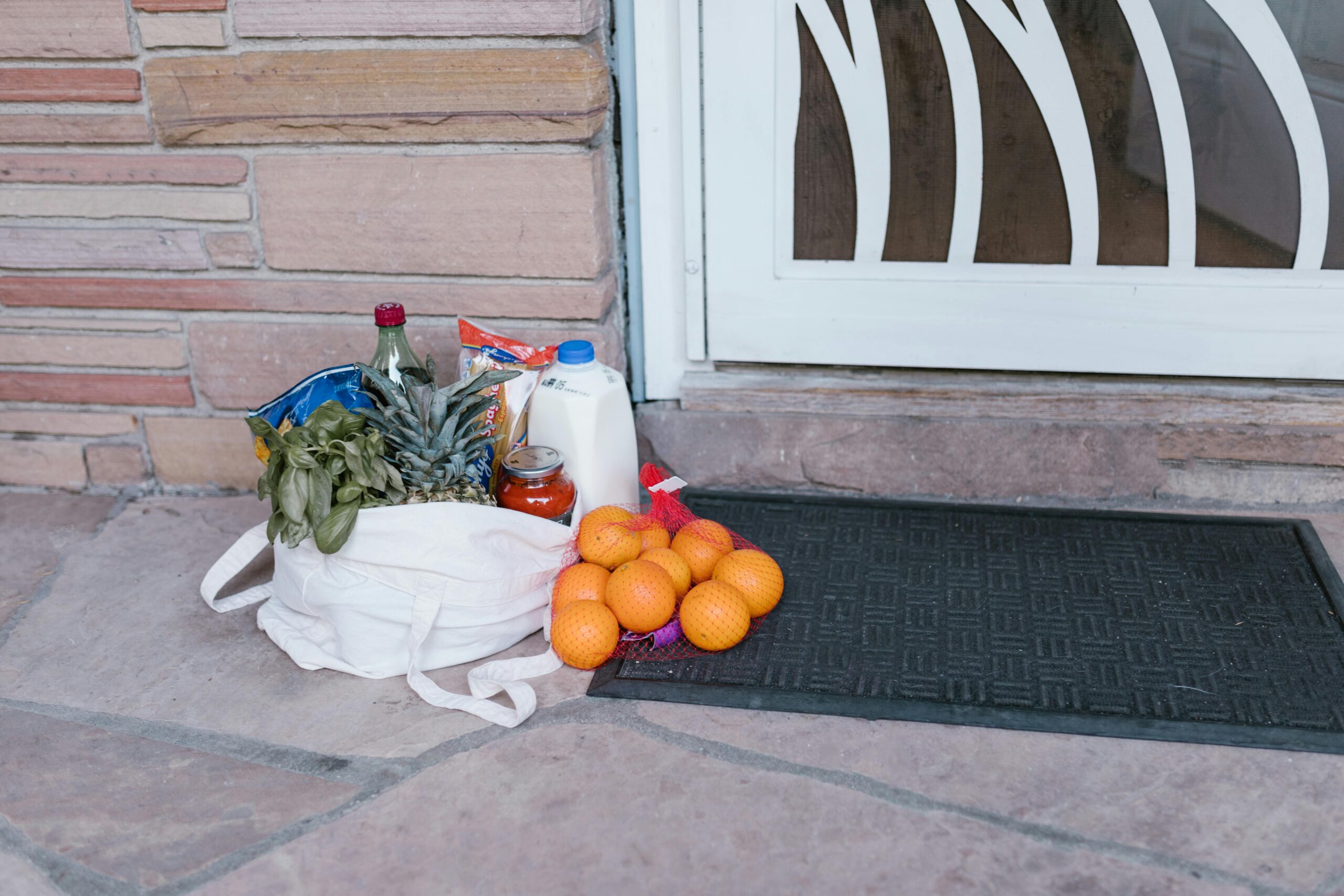Grocery delivery bags arriving at a student flat door