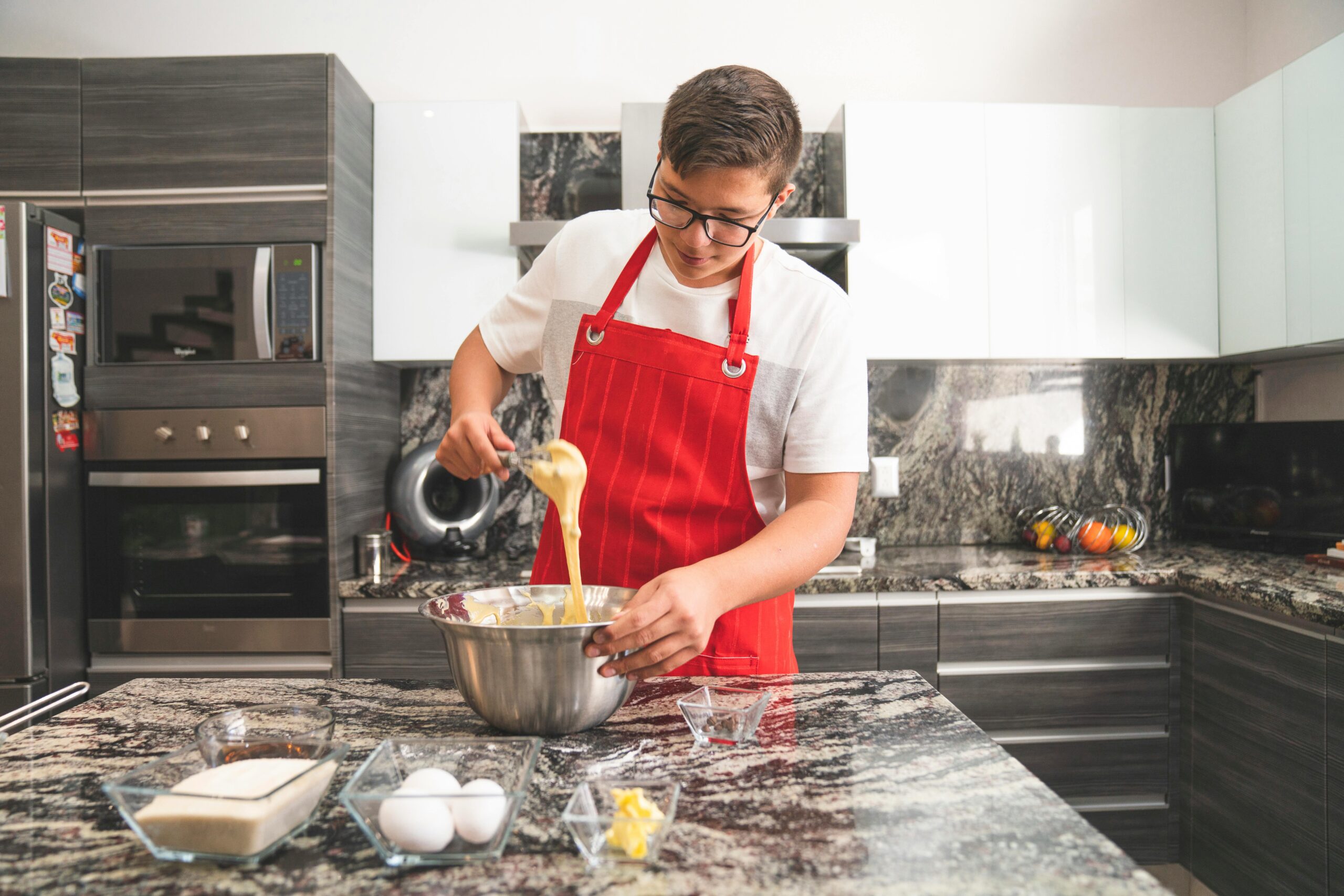 Student plating up a homemade meal in a shared kitchen