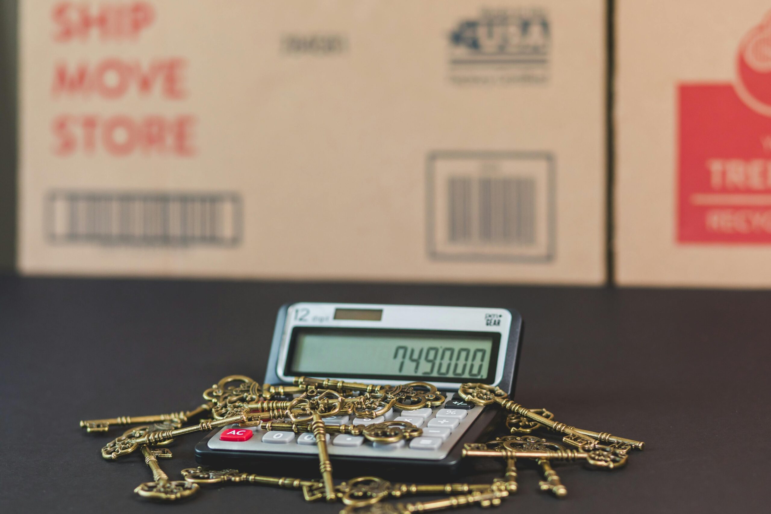 Close up of a debit card resting on an open textbook with a calculator