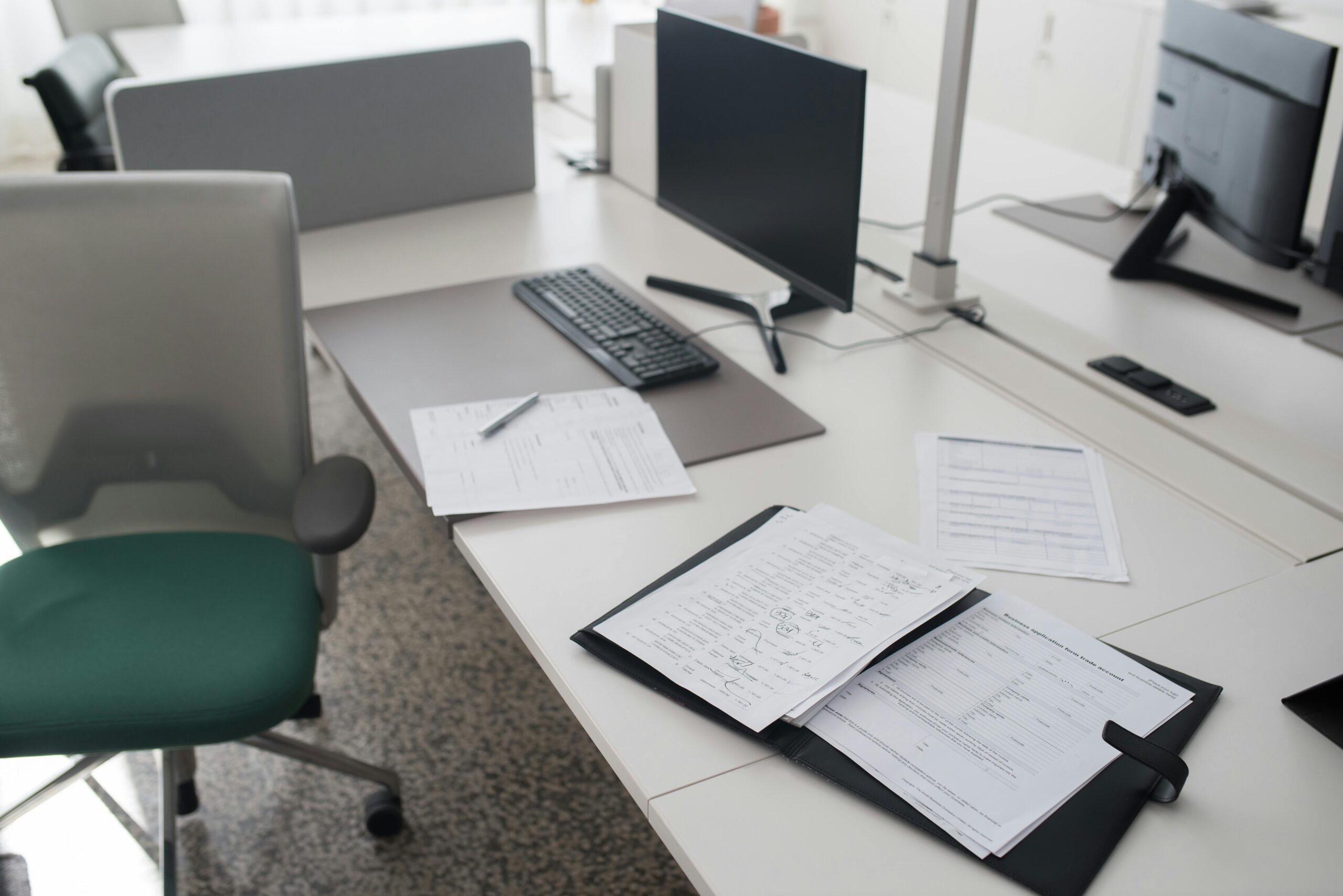 Office desk with pay documents and a cup of tea