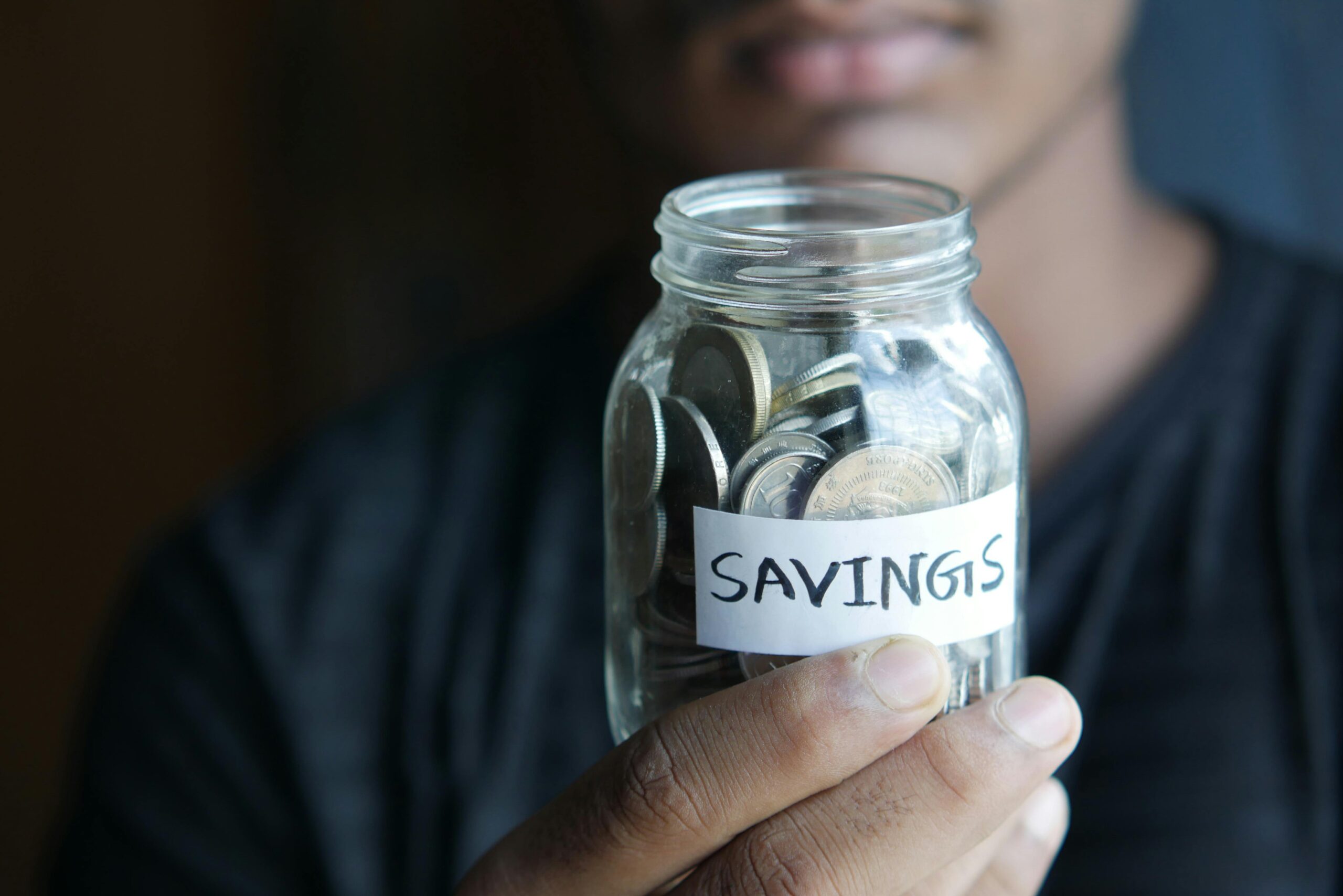 Coins and savings jar representing building financial stability after university