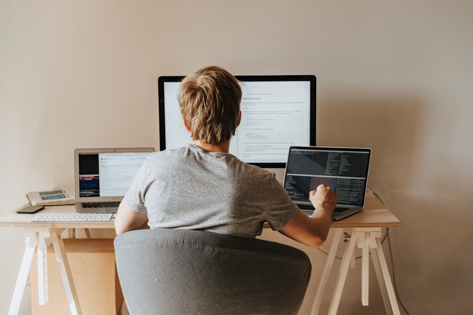 Student writing essay on a laptop