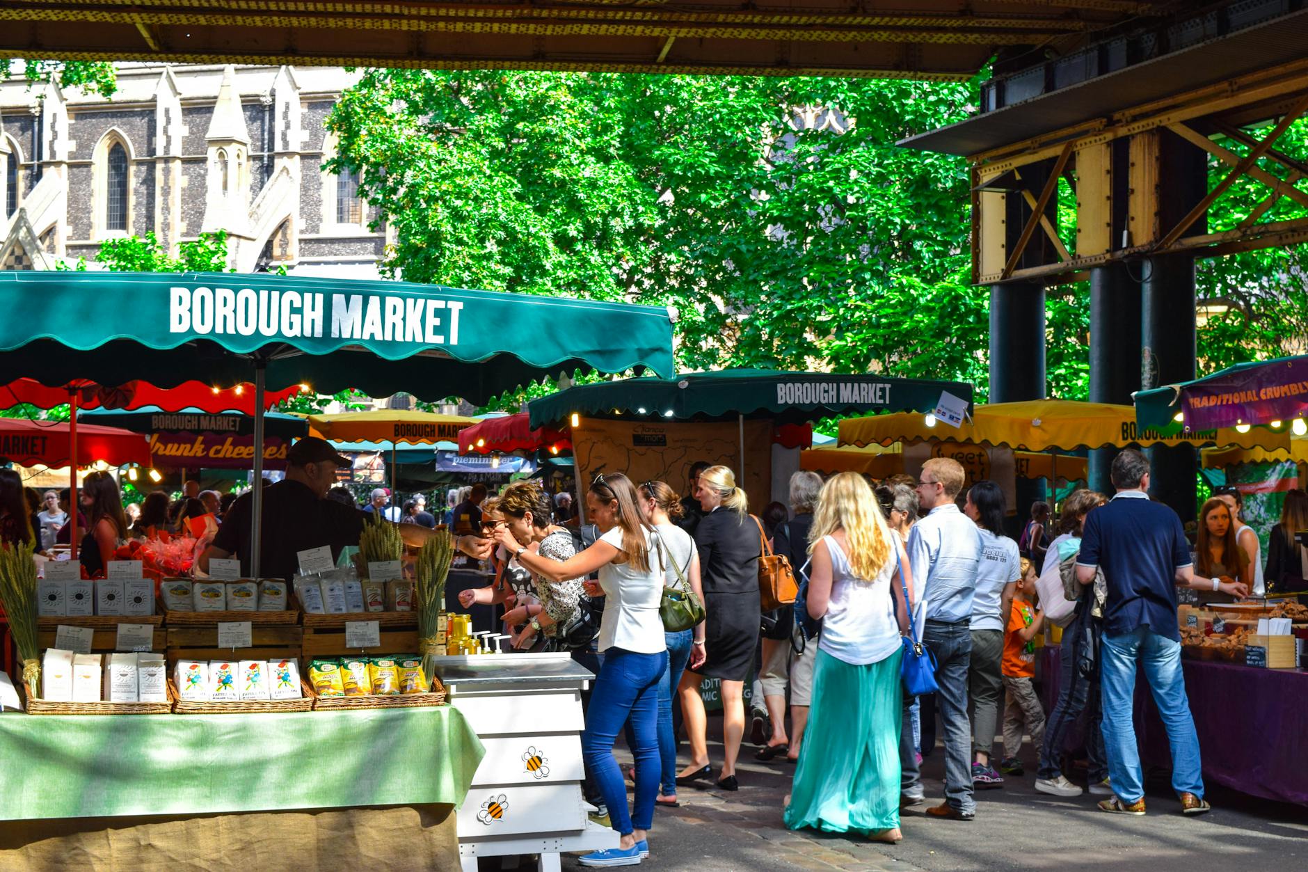 Borough Market in London with shoppers and food stalls in the daytime