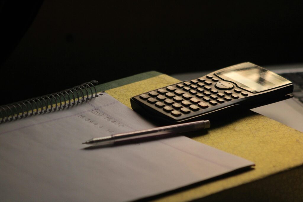 Close-up of a calculator and notebook on a study desk. Ideal for education themes.