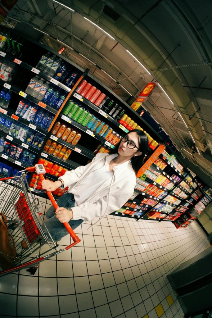 Young woman shopping for groceries in a supermarket aisle