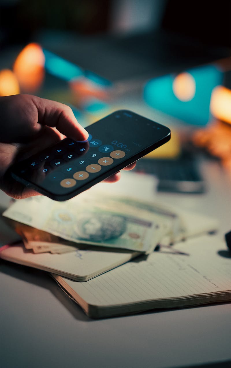 Person using a banking app on their smartphone for budgeting