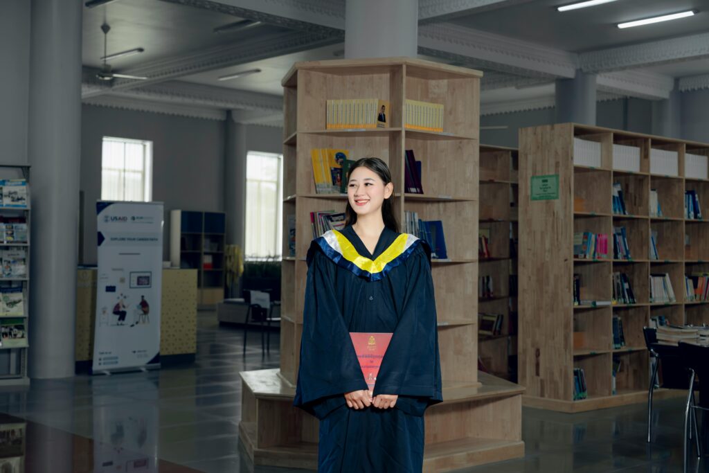 A new graduate in cap and gown, the group whose median salary these statistics track