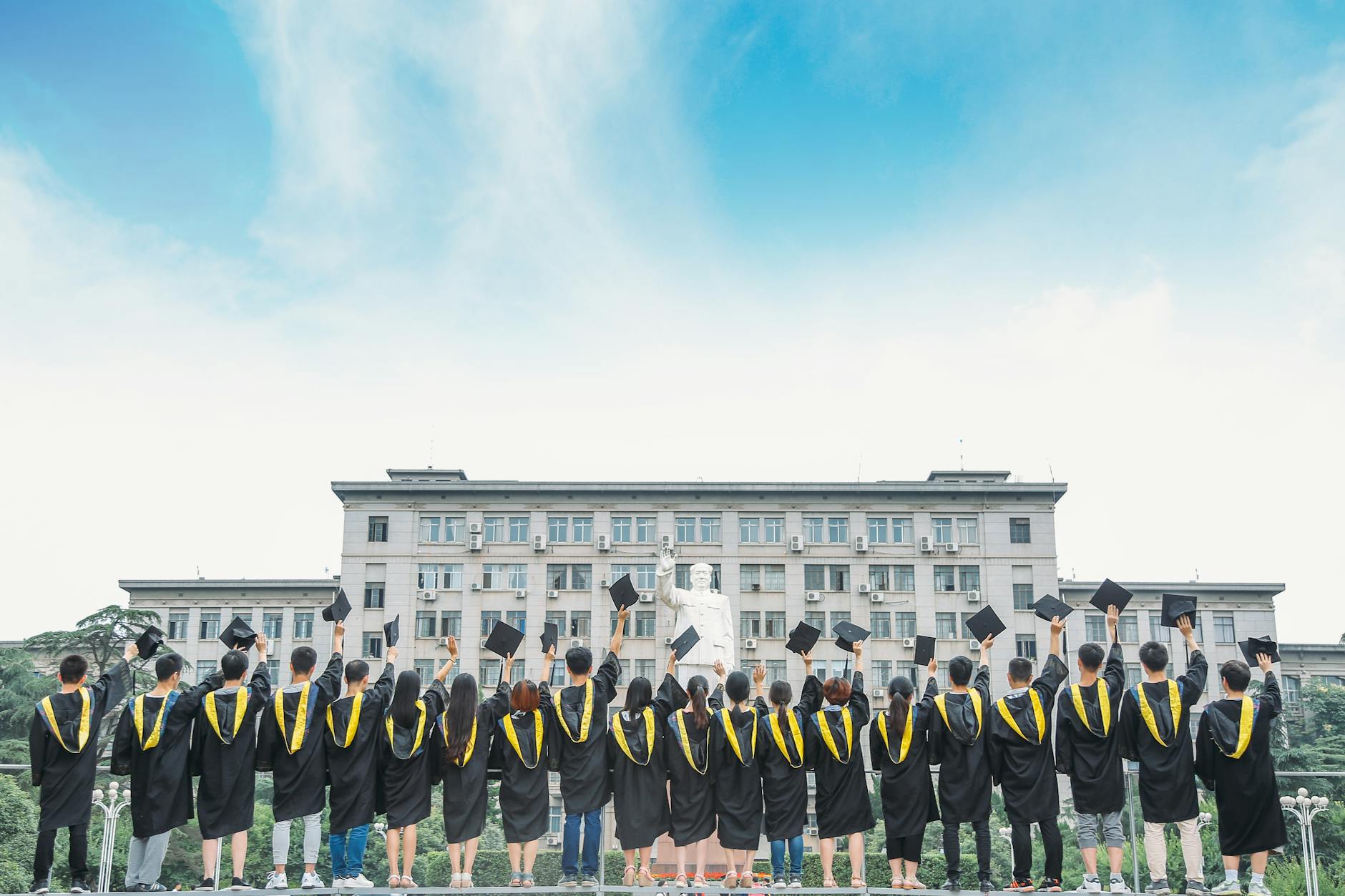 UK graduates at a university graduation ceremony, marking the start of Plan 2 repayments
