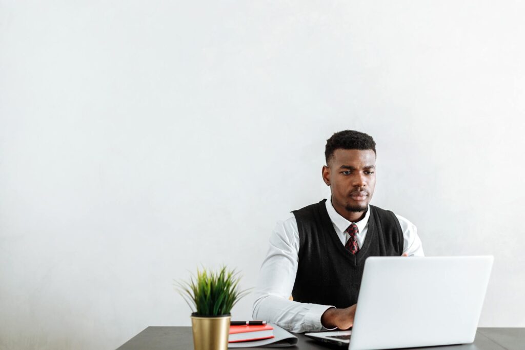 Young professional writing LinkedIn About section at desk