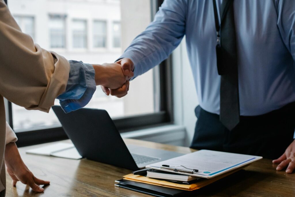 job interview handshake office desk