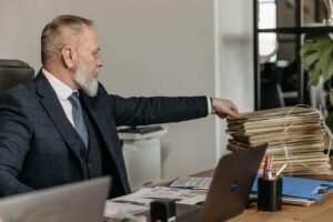Mature student looking at paperwork at a desk with concerned expression