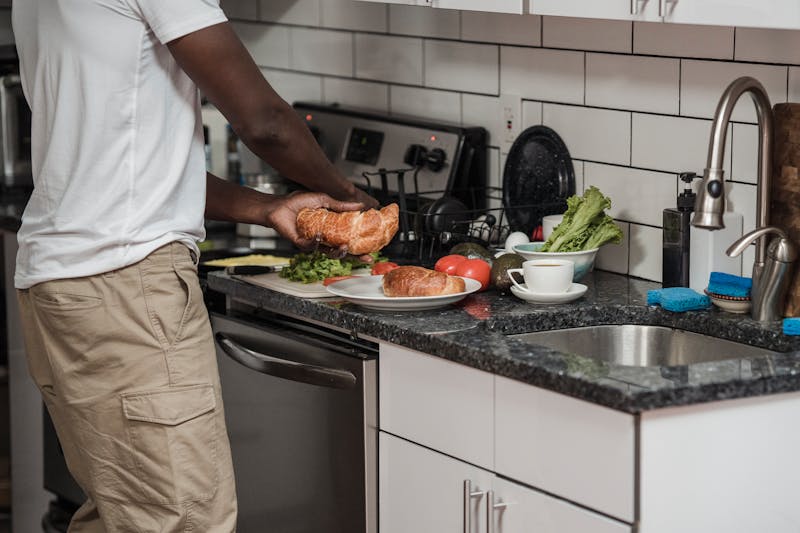 Person preparing a meal with fresh ingredients in a modern kitchen