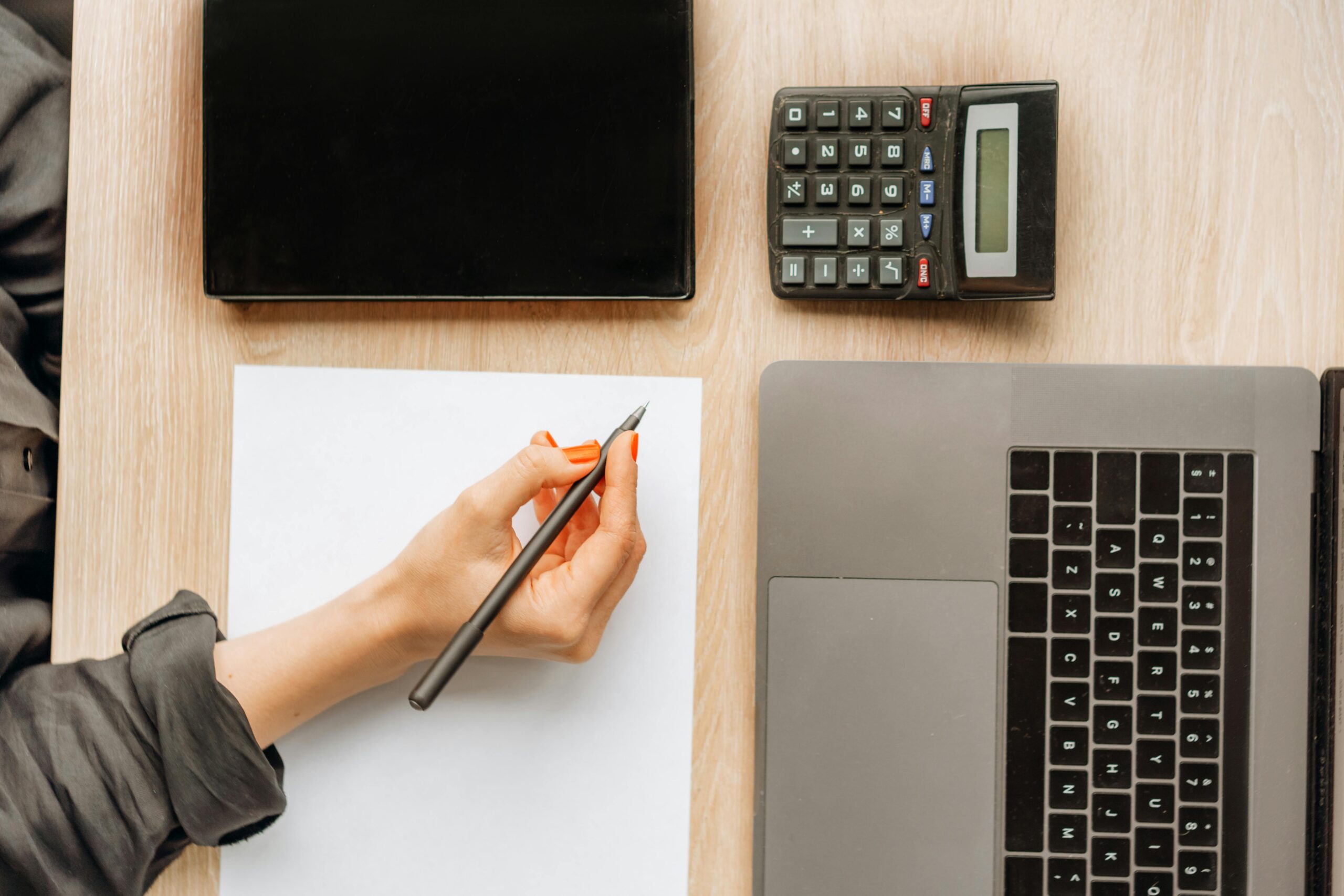 Calculator next to a payslip for checking tax and NI