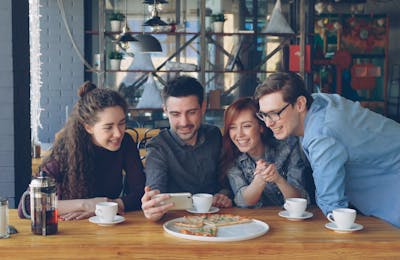 Friends at a cafe sharing food