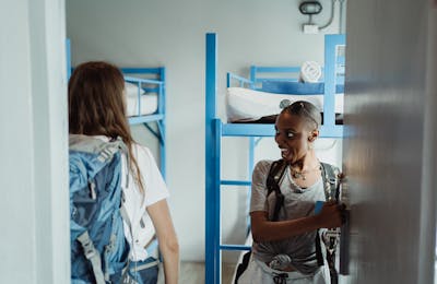 Students arriving at accommodation with backpacks