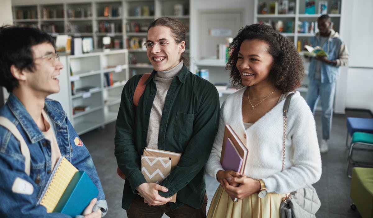 Students laughing together in a university library