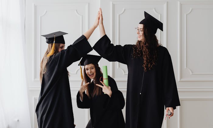 Three young women celebrating graduation