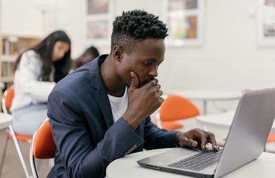 Student at laptop in a modern classroom