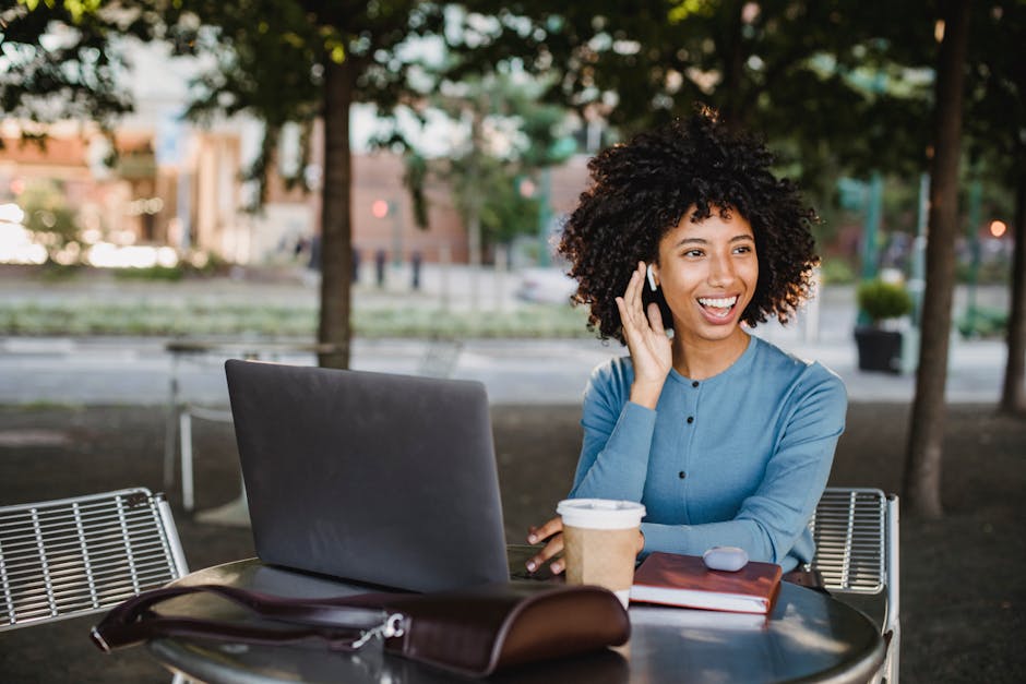 Young woman studying on a laptop at a cafe with coffee