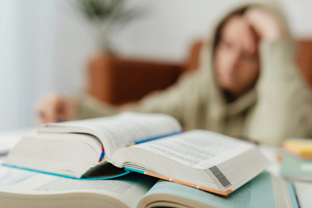 Student revising for exams with flashcards at a desk