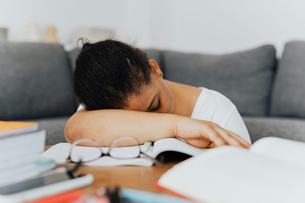 Tired student needing rest during exam revision season