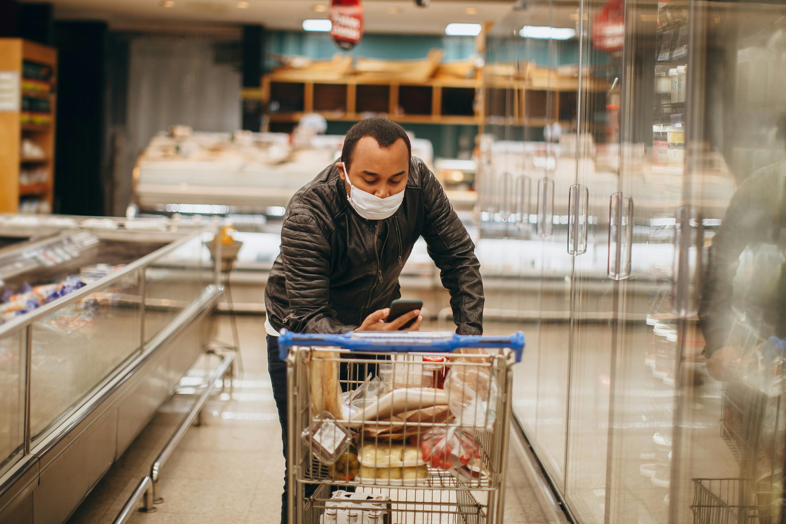 Timing your shop for supermarket reductions, student in supermarket aisle