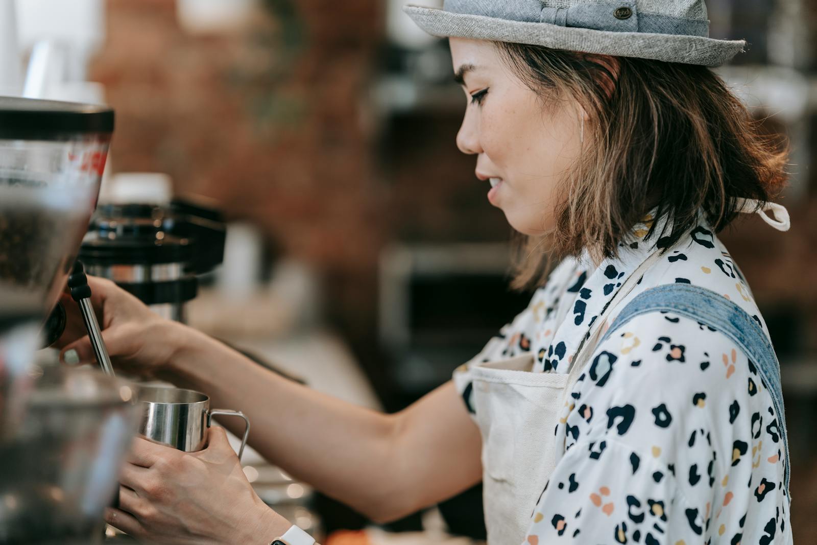 Young barista pulling a coffee in a UK cafe over the summer
