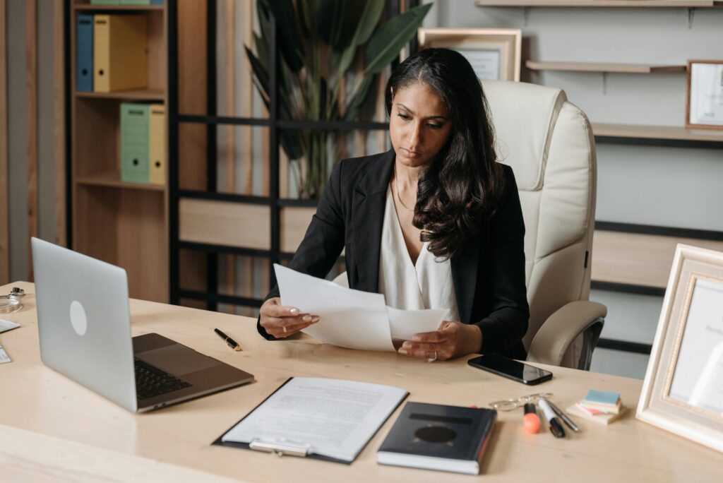 Graduate reviewing contract and salary terms on a laptop