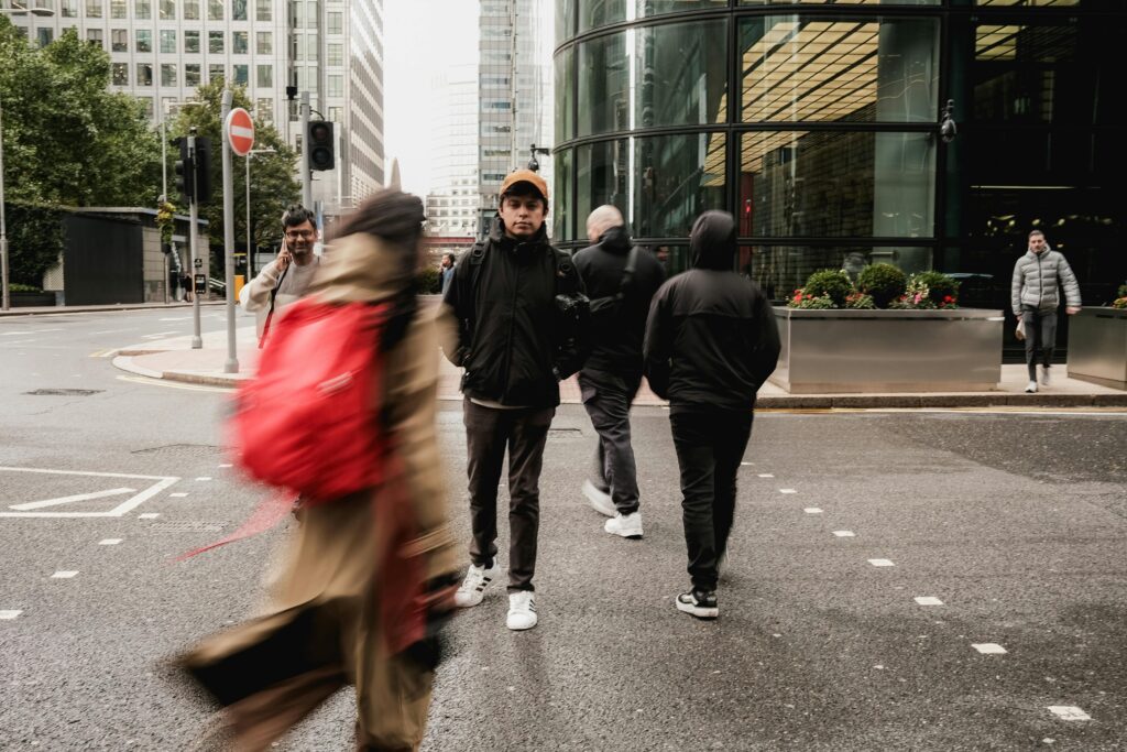A busy London street intersection with people walking in motion blur, capturing the urban hustle.