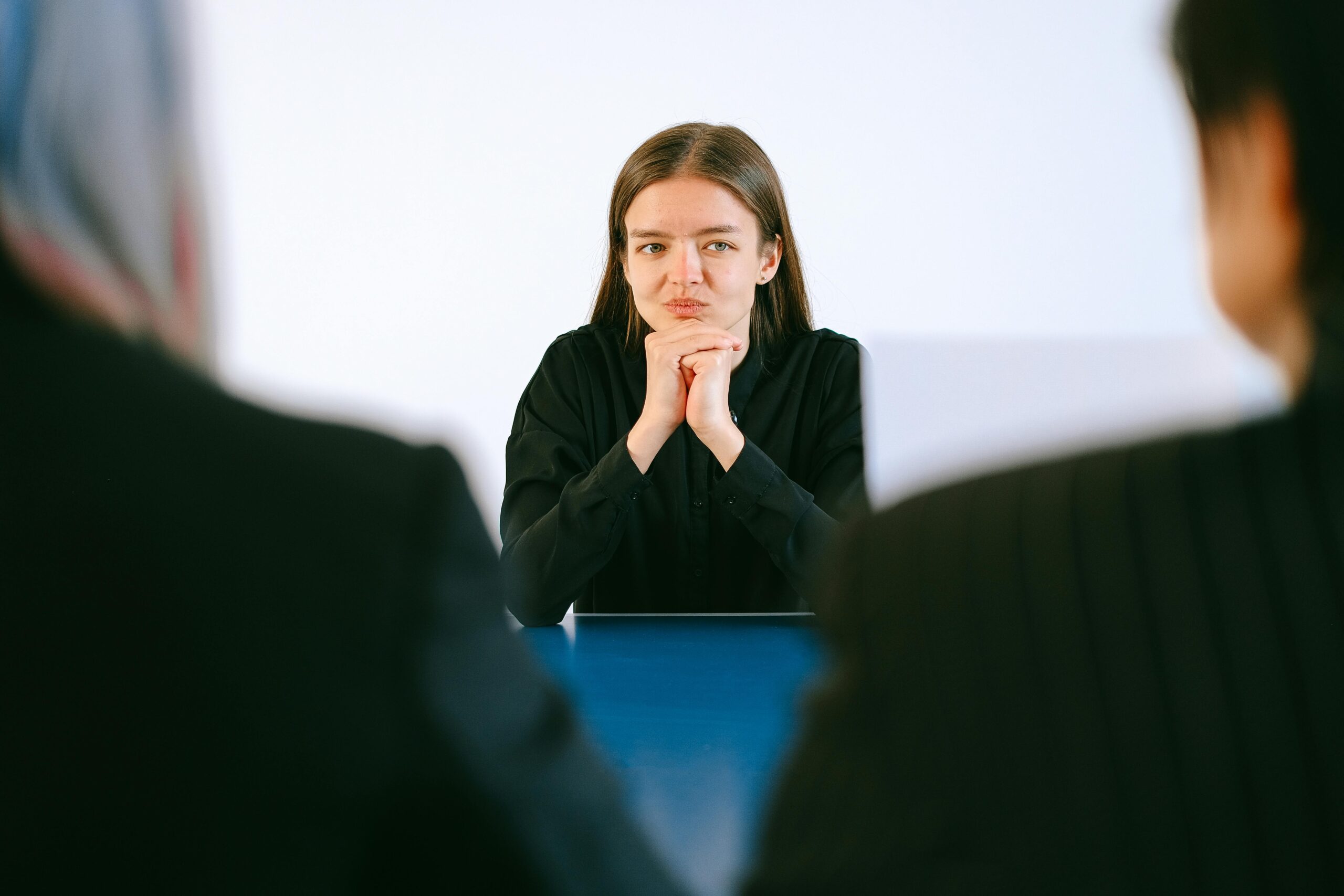 Close up of a candidate's hands holding an annotated personal statement during an interview