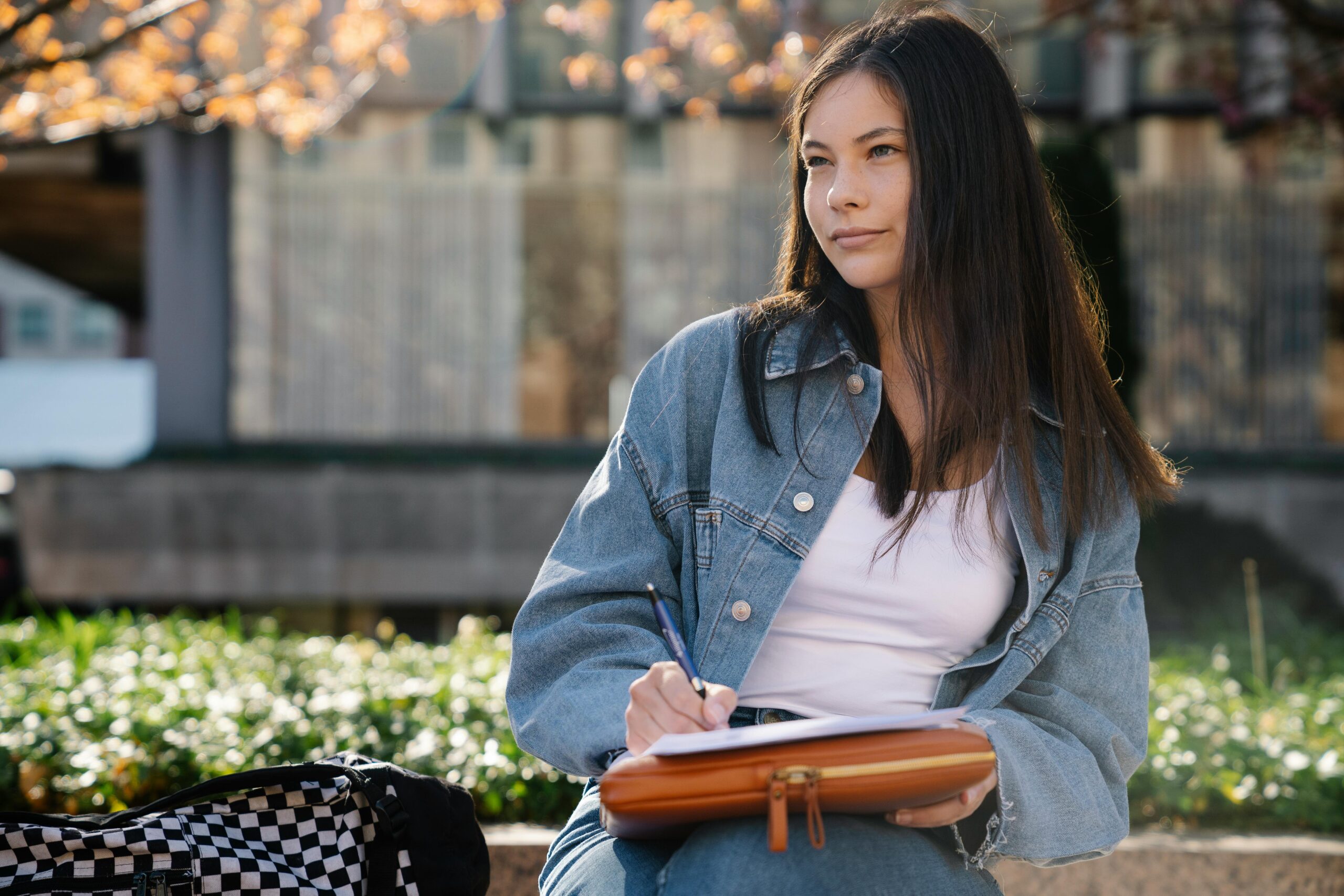 A student calculating living costs and rent on a tablet
