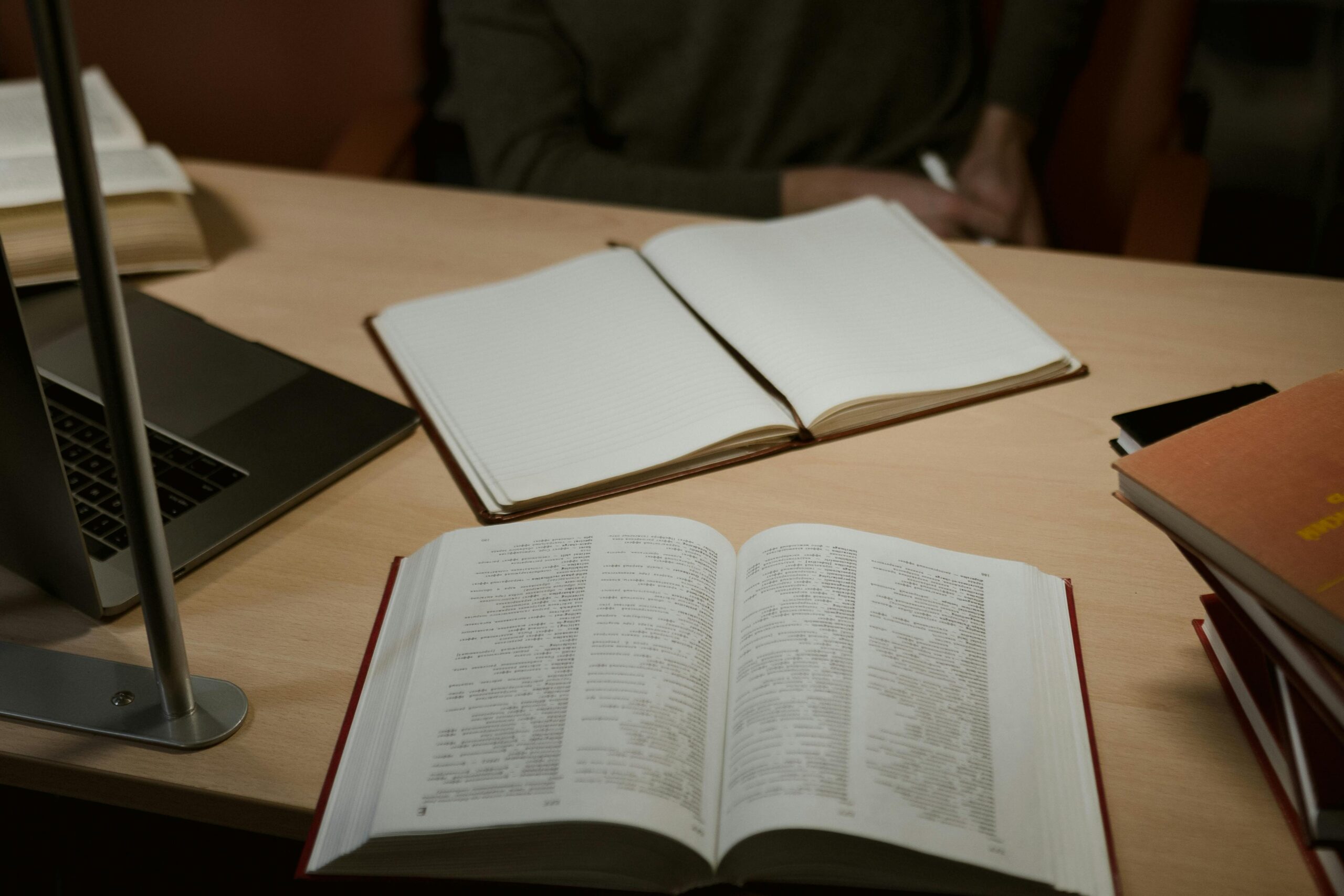 Student researching academic integrity policies at university library desk