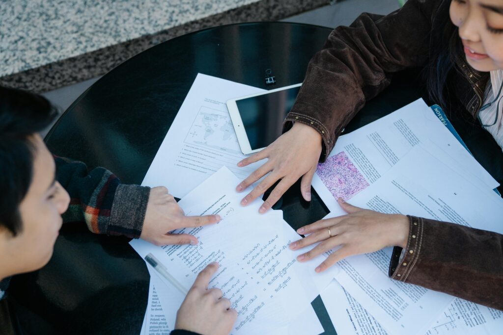 Group of college students studying together in a classroom
