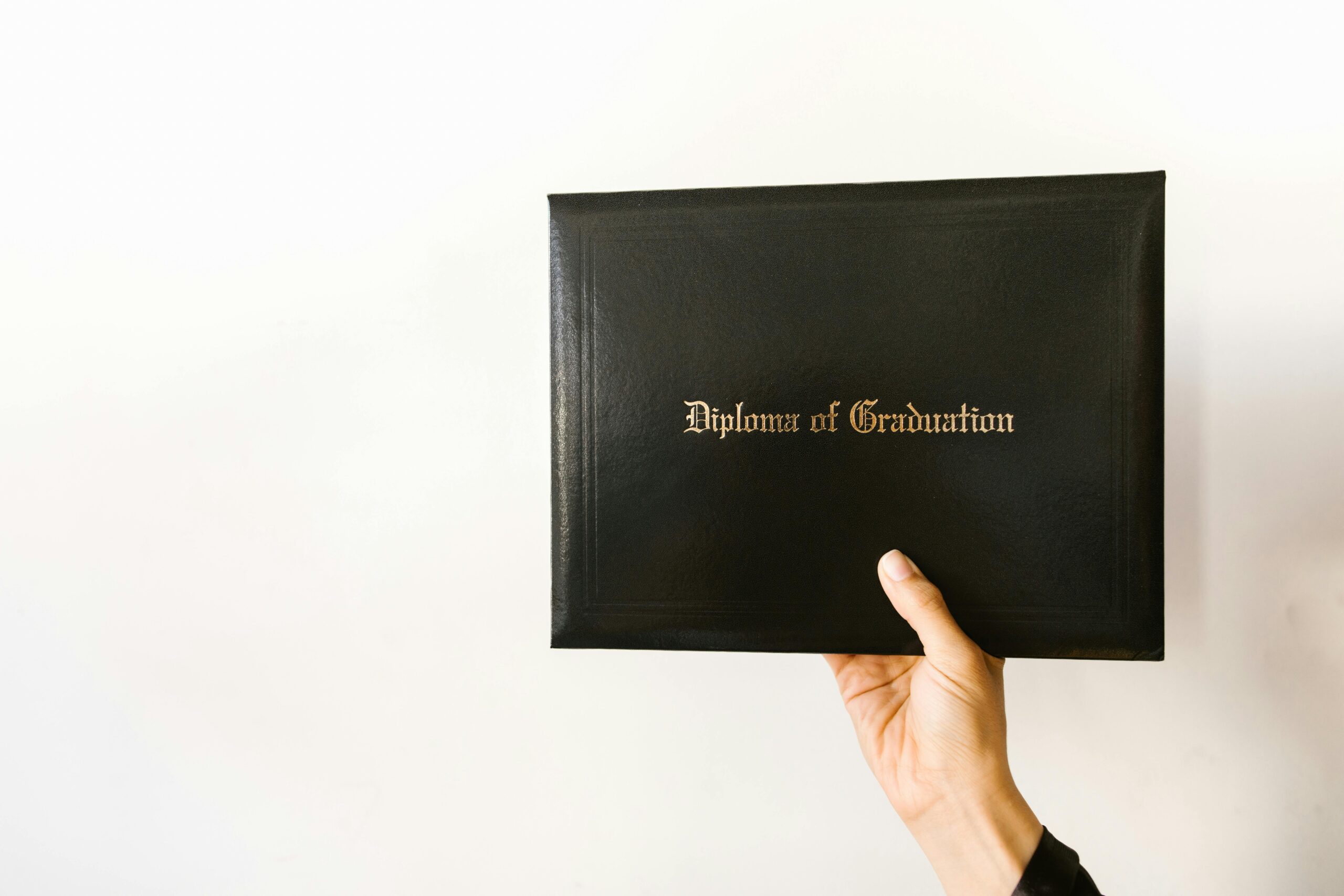 Graduate holding a diploma certificate after completing a course