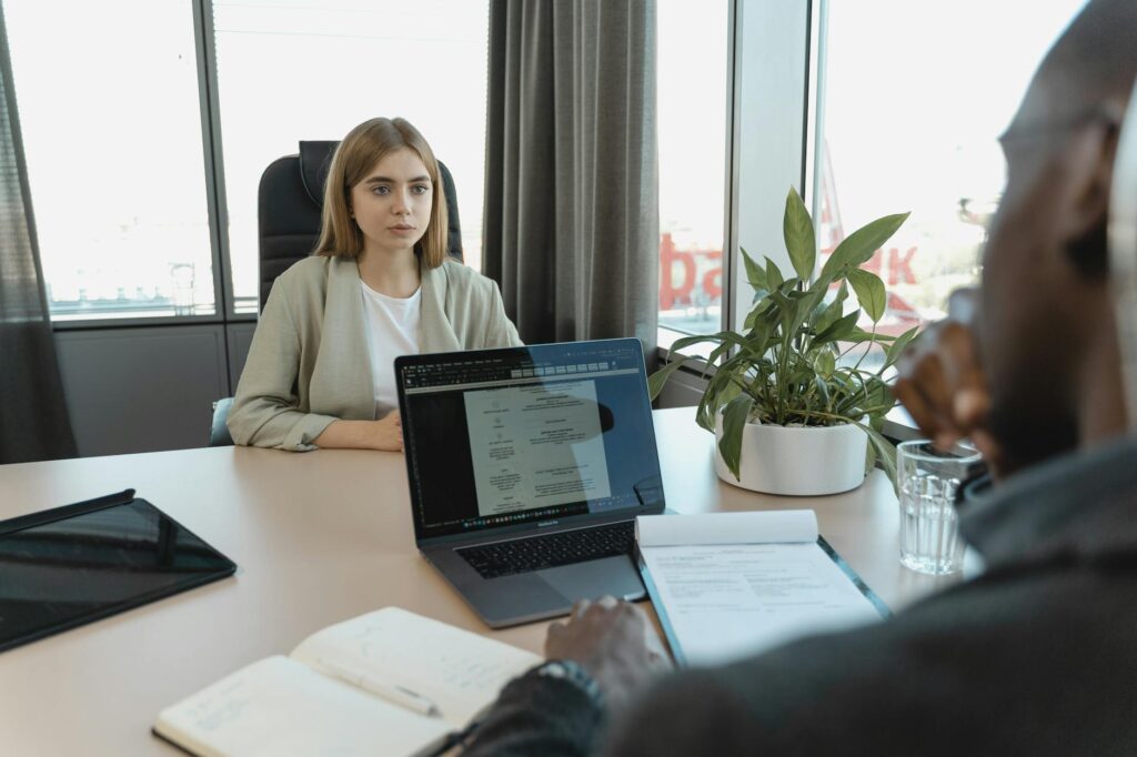 Graduate sitting a job interview at a desk