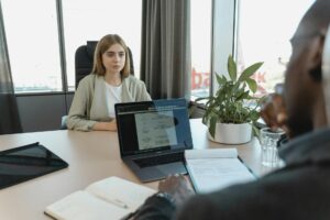 Graduate sitting a job interview at a desk