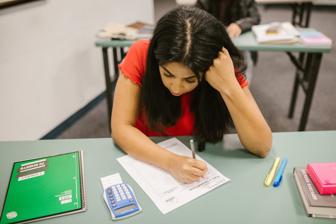 Student focused at desk during exam season