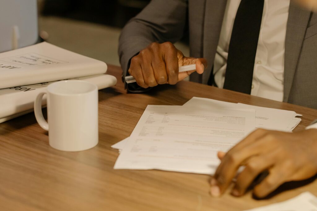 A graduate reviewing a first payslip and salary breakdown at a desk