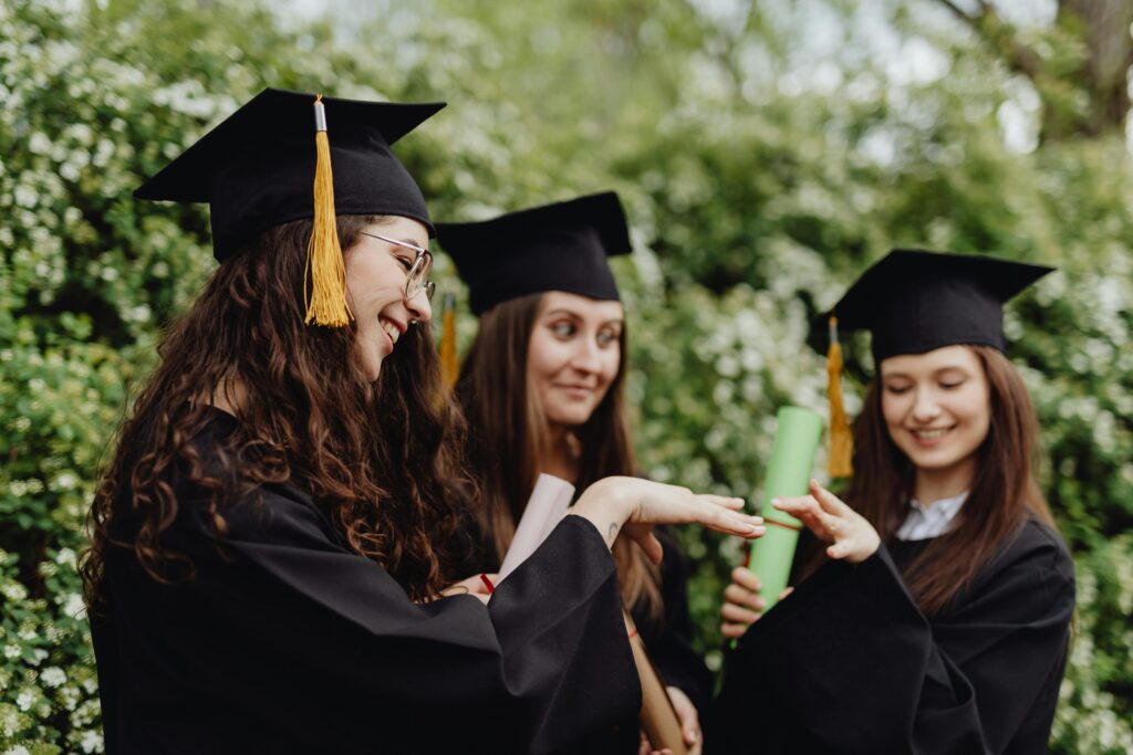 Recent graduates celebrating in caps and gowns