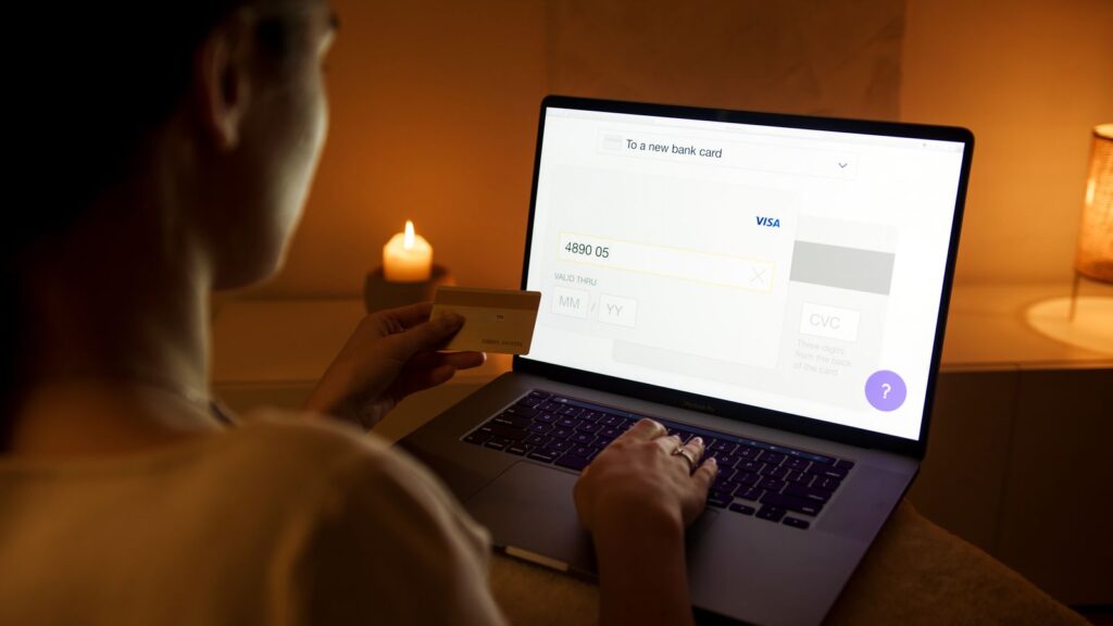 Checking bank card details on a laptop after a data breach