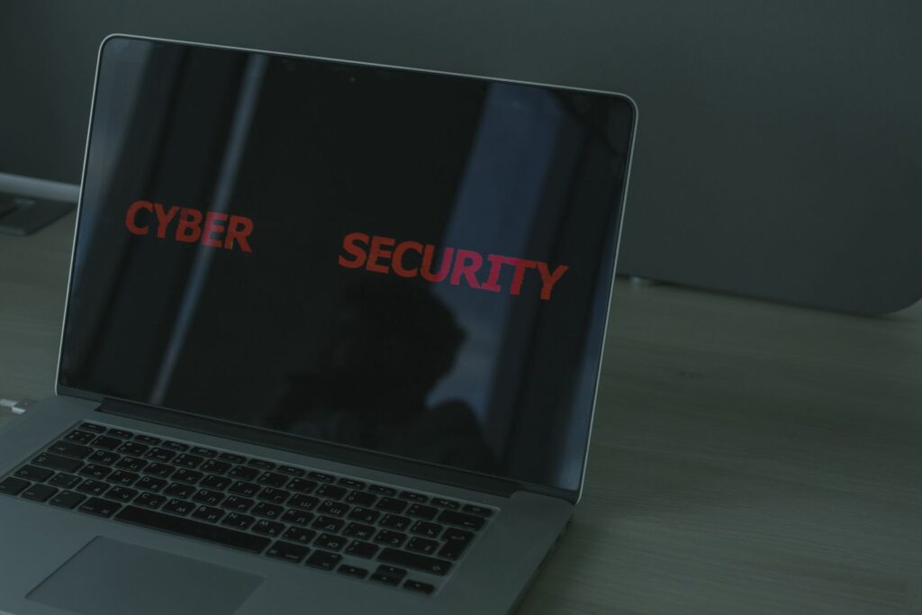 A laptop screen showing the words cyber security