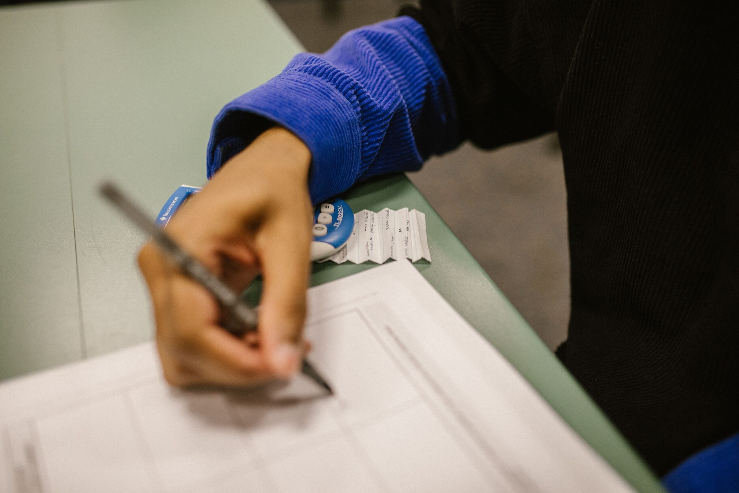 A student looking over their exam results, weighing whether a missed grade is worth a remark