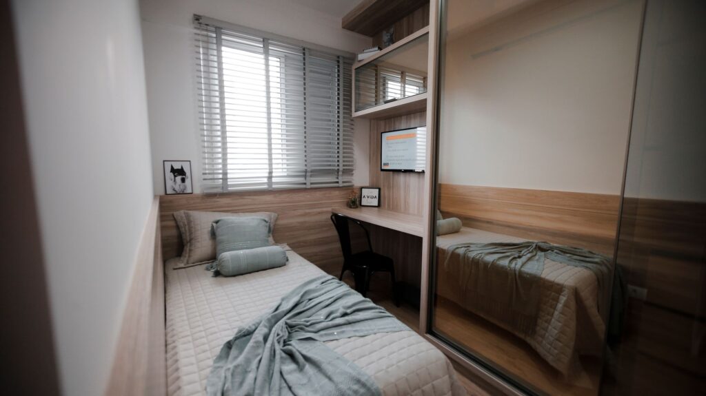 Compact student halls bedroom with a single bed, built-in desk and fitted wardrobe