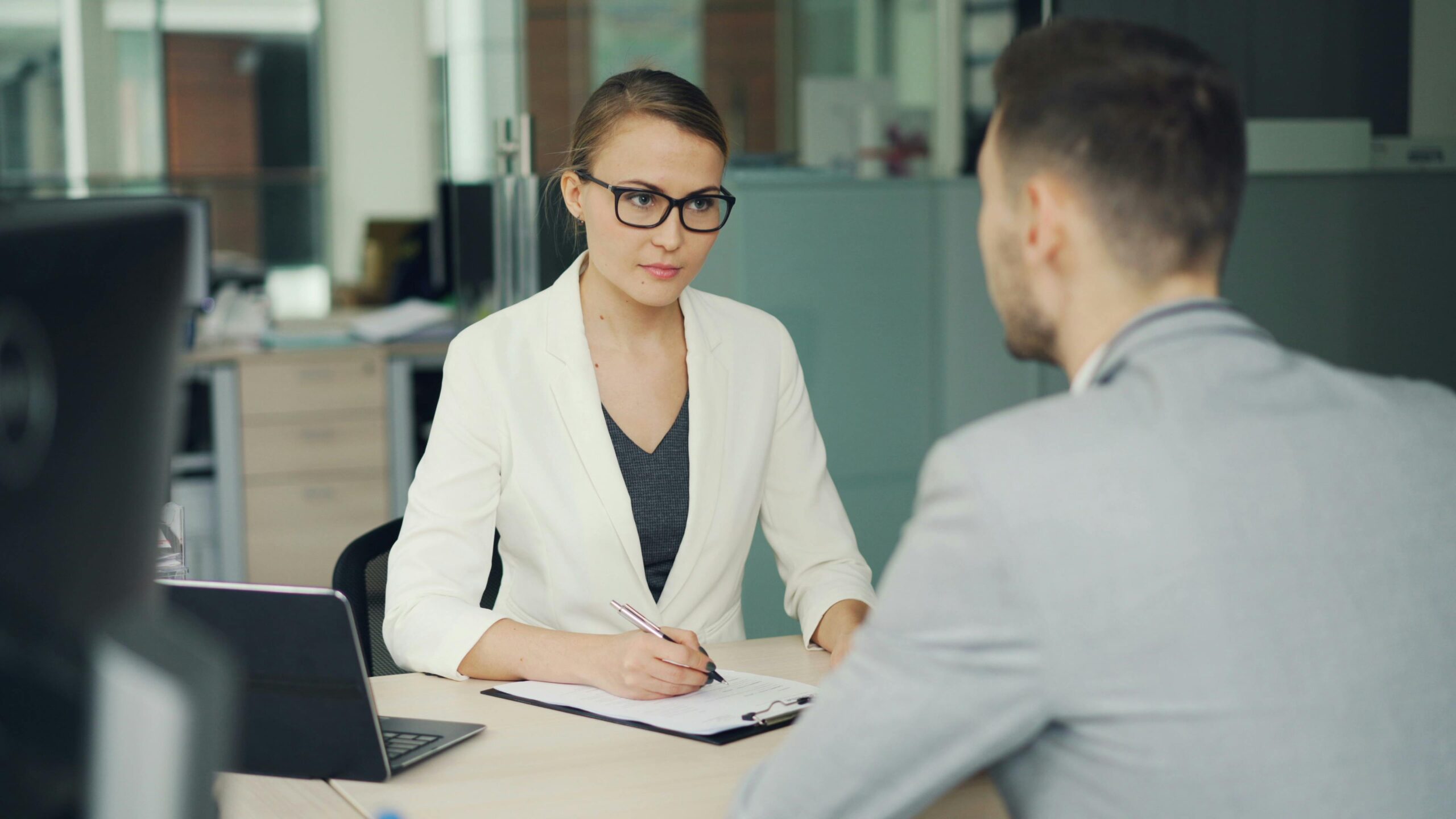 Two people in a meeting at an office table